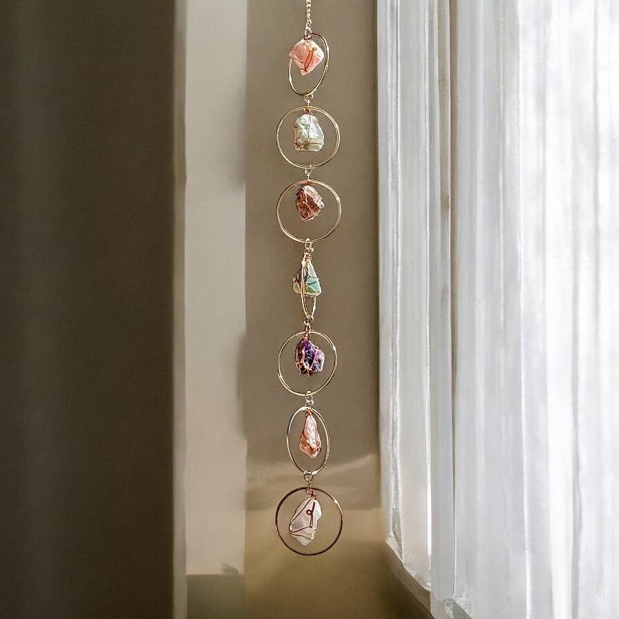 Decorative Rough Crystals + Gold Rings Wall Hanging with colorful stones in front of a window