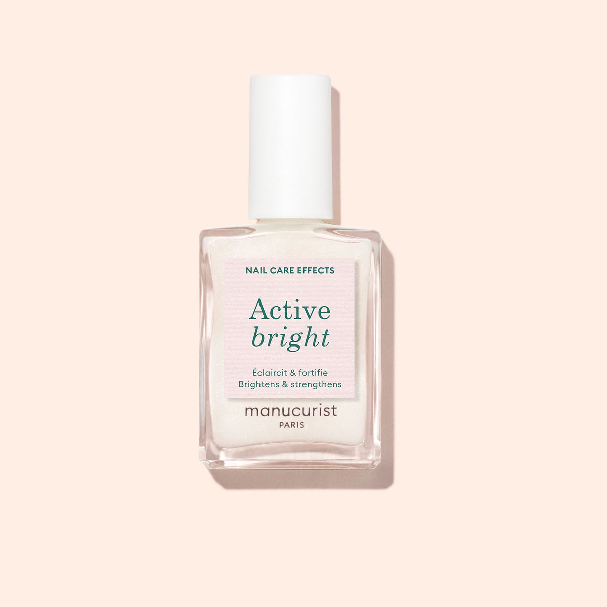 Manucurist Active Bright 15 mL bottle on a pale peach background