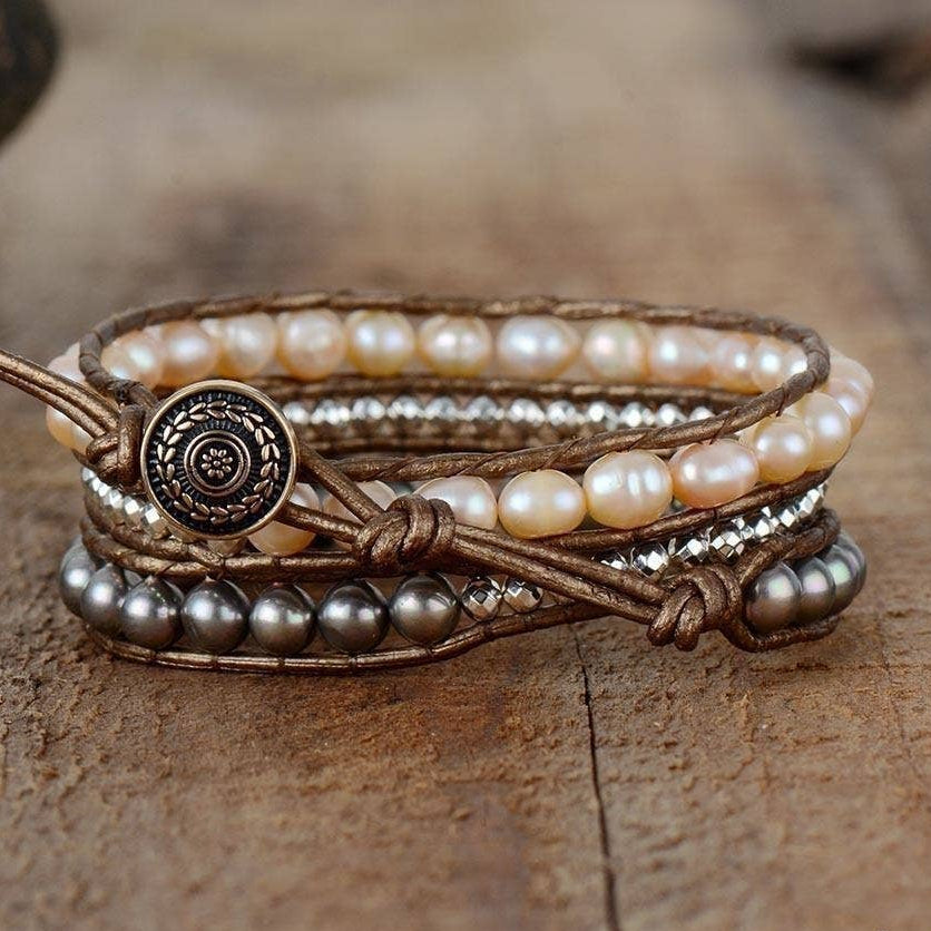 Multi-layered bracelet with pearls and beads on a wooden surface