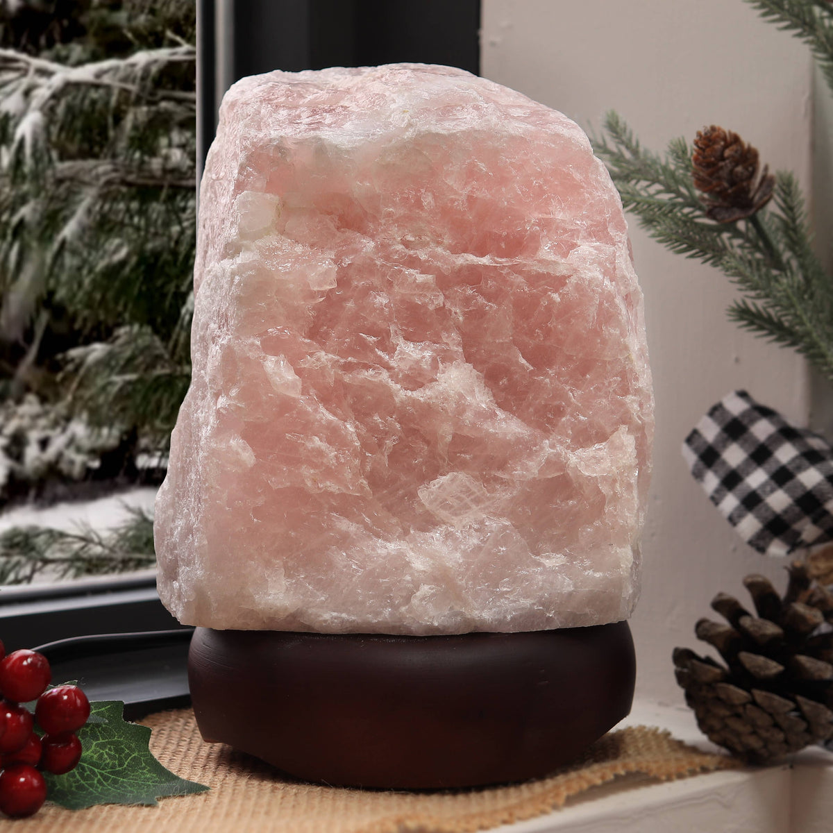 Rose Quartz lamp on a wooden surface with decorative elements in the background