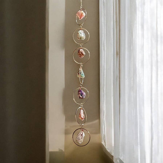 Decorative Rough Crystals + Gold Rings Wall Hanging with colorful stones in front of a window