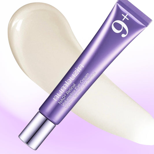 A tube of numbuzin - No.9 NAD+ Retinal Volumetox Eye Cream in a metallic purple packaging with a silver cap, shown diagonally over a cream-colored eye cream smear on a white and light purple gradient background.