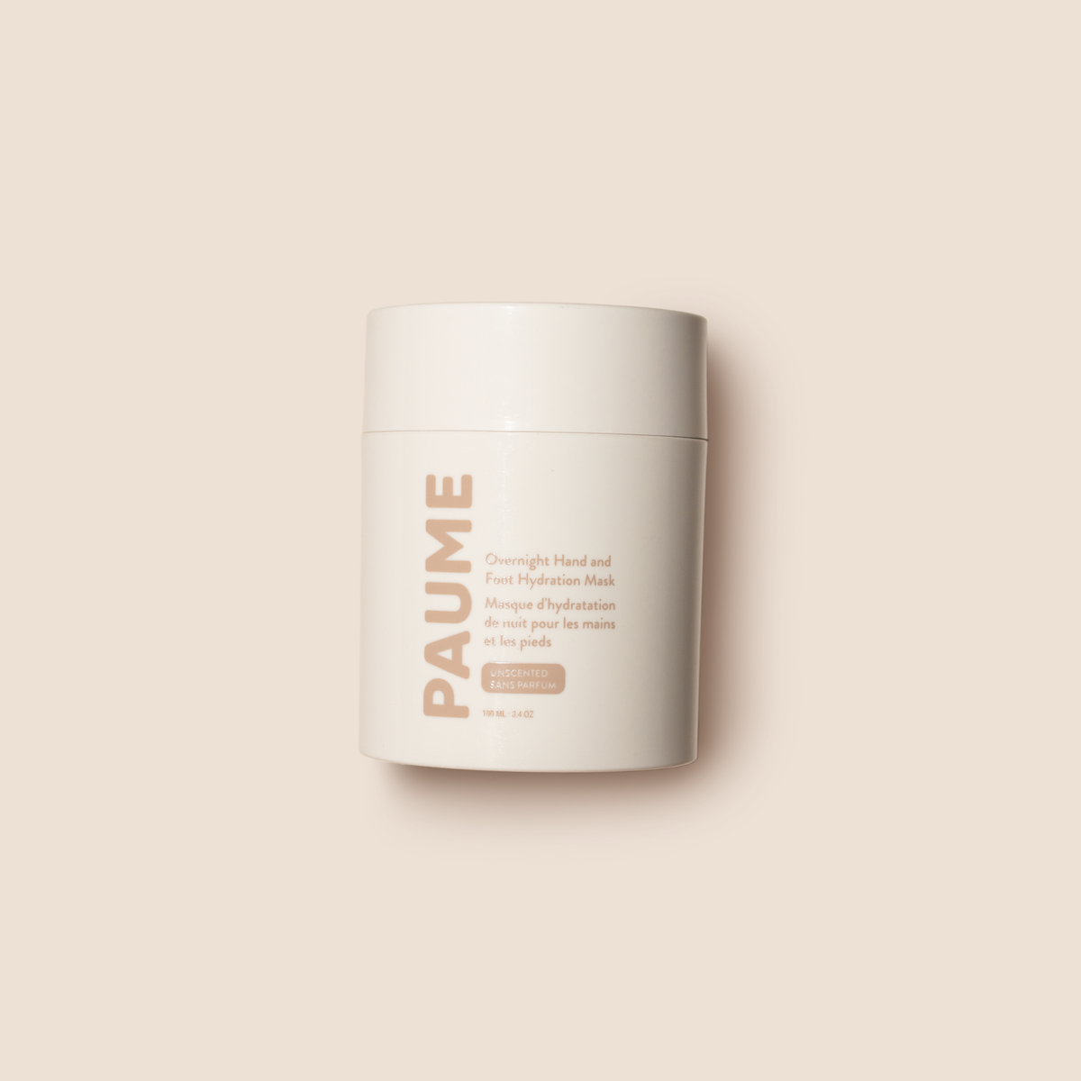 White jar with PAUME Overnight Hand & Foot Hydration Mask on a beige background