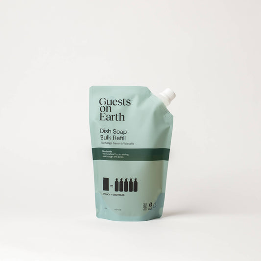 Guests on Earth Woodlands Dish Soap bulk refill pouch on a white surface.