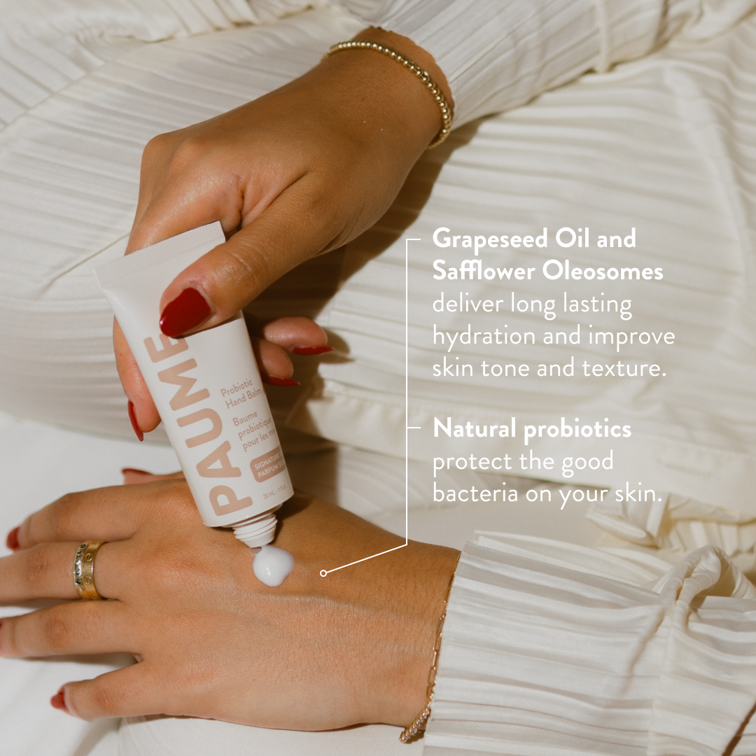 Hand applying PAUME Hand Balm with text about ingredients and benefits.