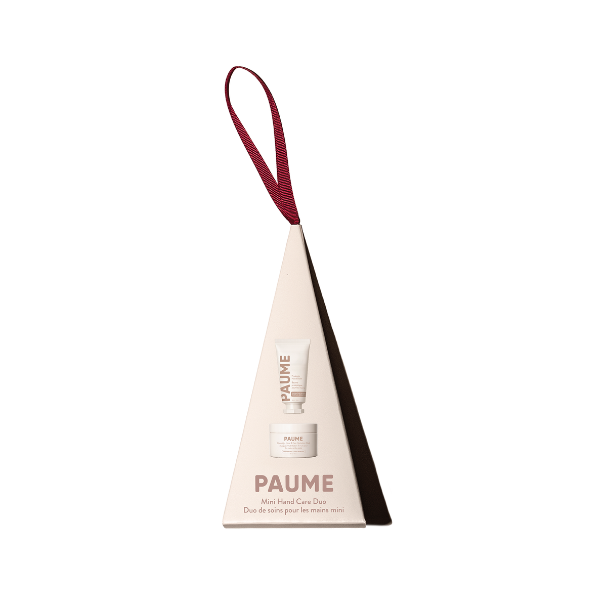 PAUME hair care set in a triangular cardboard holder with a burgundy hanging loop, shown on a plain white background.