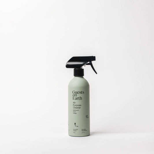 Guests on Earth Woodlands All-Purpose Cleaner in a pale green bottle with a black trigger sprayer.