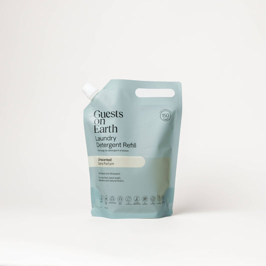Guests on Earth Unscented Laundry Detergent bulk refill pouch on a white surface.