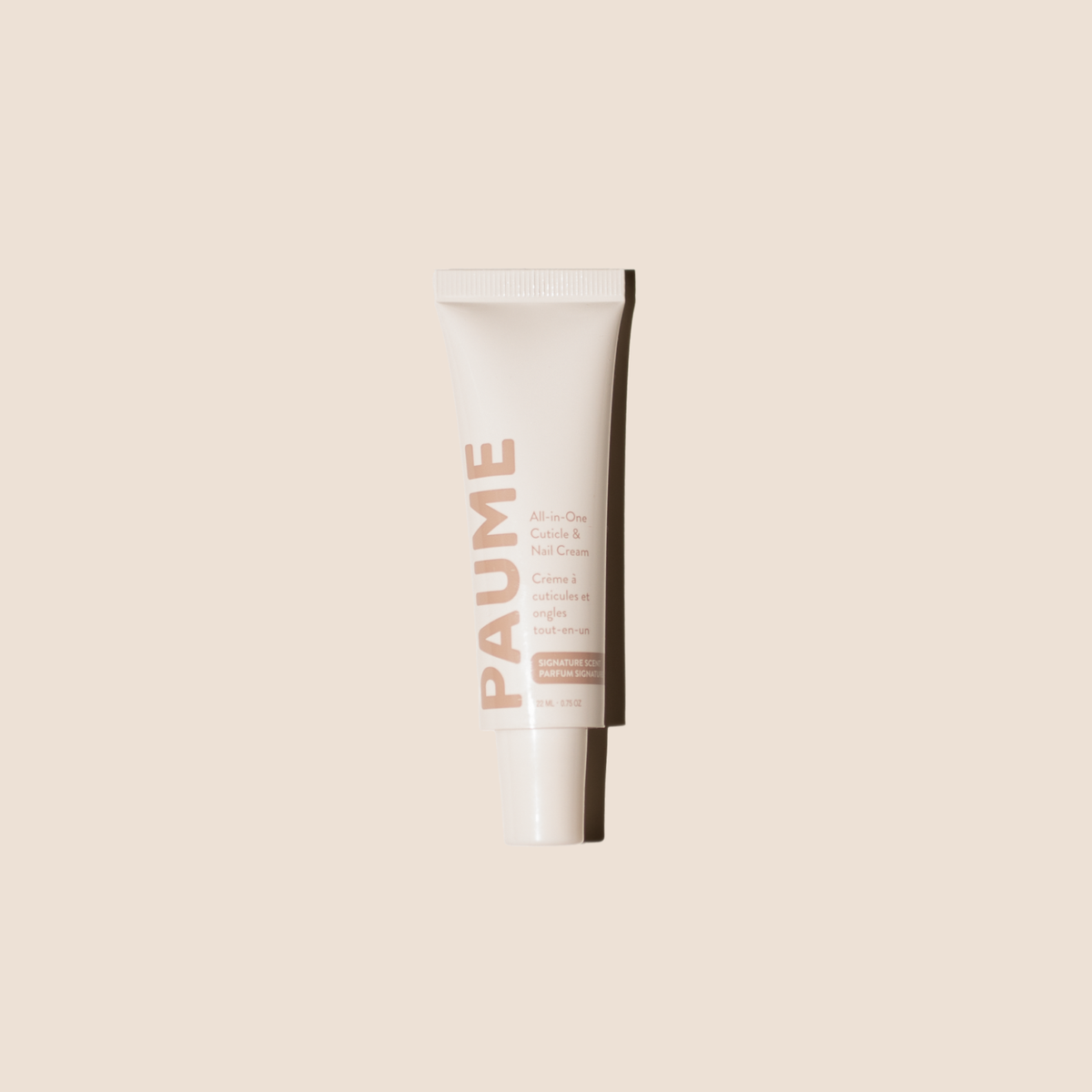 White tube of PAUME All-in-One Cuticle & Nail Cream on a beige background