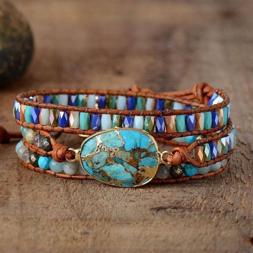 Multistrand beaded bracelet with turquoise stone on a wooden surface