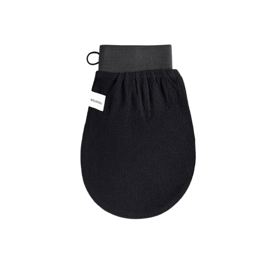 Wildpier Luxe Exfoliating Glove - black textured hand wash mitt with a dark gray elastic wrist strap and a small white brand tag, shown on a plain white background.