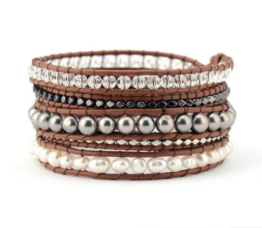 Stack of multicolored beaded bracelets on a white background