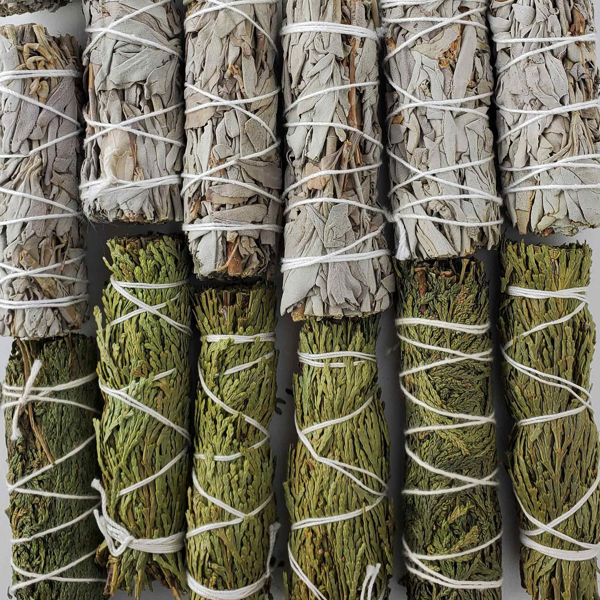 Assorted tied sage and cedar smudge bundles