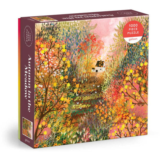 Puzzle box with autumn-themed artwork featuring a house and trees.