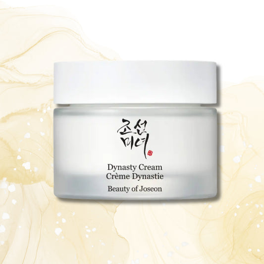 A frosted glass cosmetic jar with a white lid, labeled 'Dynasty Cream' and 'Beauty of Joseon' with black text and a small red seal, centered on a soft cream marbled background.