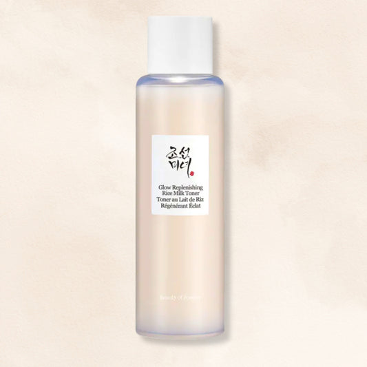 Beauty of Joseon Glow Replenishing Rice Milk Toner in a translucent frosted bottle with a white cap, set against a warm beige textured background.