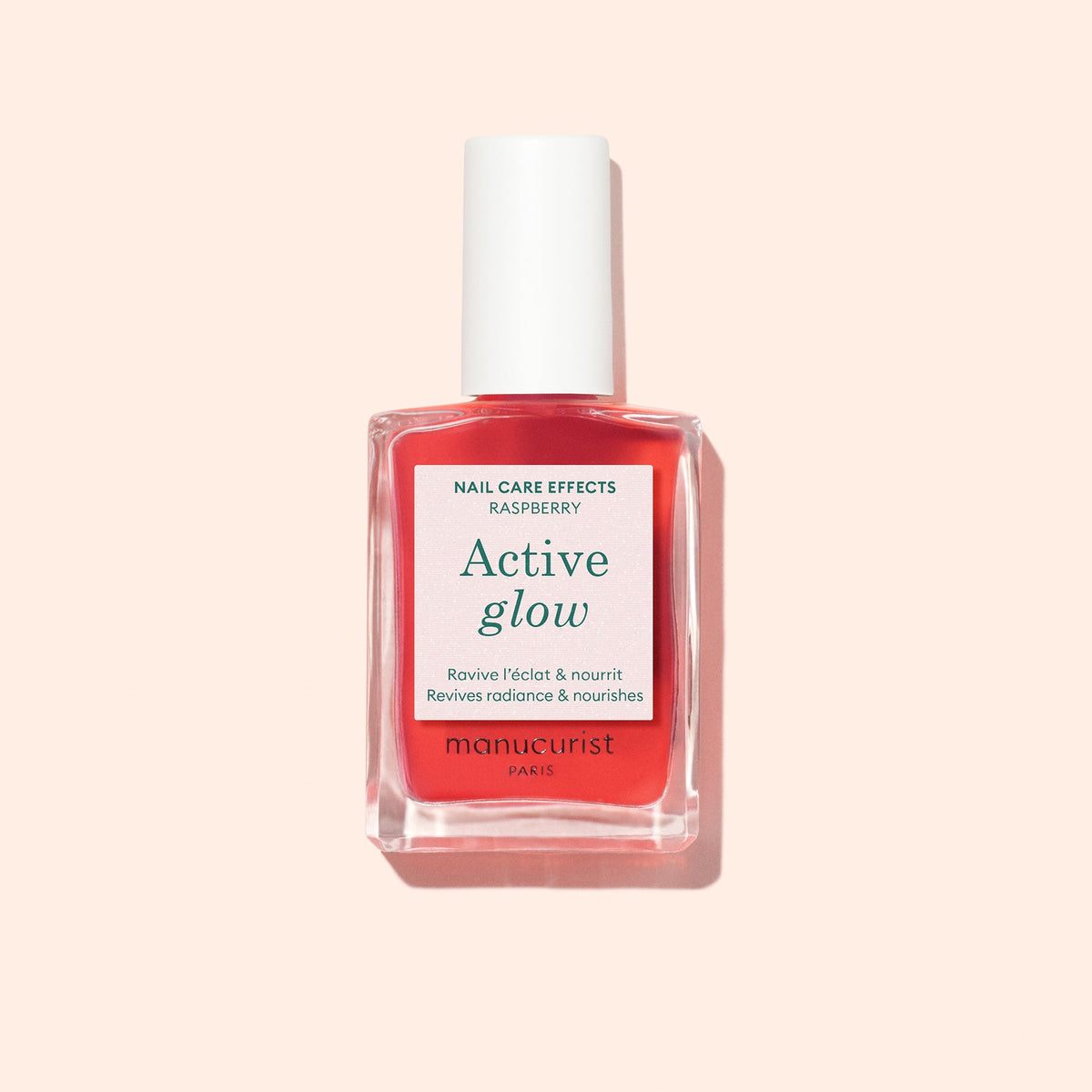 Manucurist Active Glow Raspberry 15 mL bottle on a pale peach background