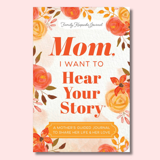 A floral family keepsake journal cover with the title 'Mom, I Want to Hear Your Story' in large orange-red text on a warm off-white background, surrounded by watercolor-style flowers in coral, orange, yellow, and muted green. The subtitle reads 'A Mother's Guided Journal to Share Her Life & Her Love.