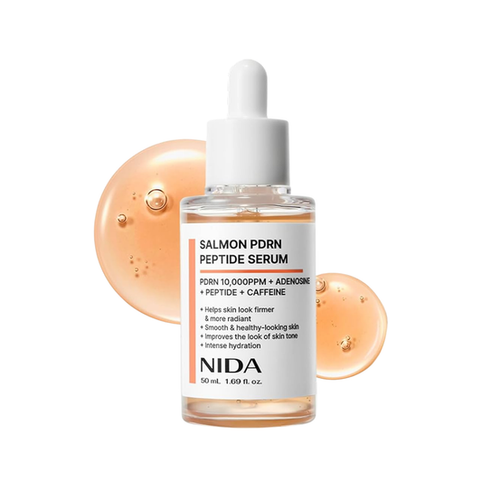 NIDA Salmon PDRN Peptide Serum in a 50 mL clear bottle with a white dropper cap, shown on a white background with two peach-colored serum droplets behind it.