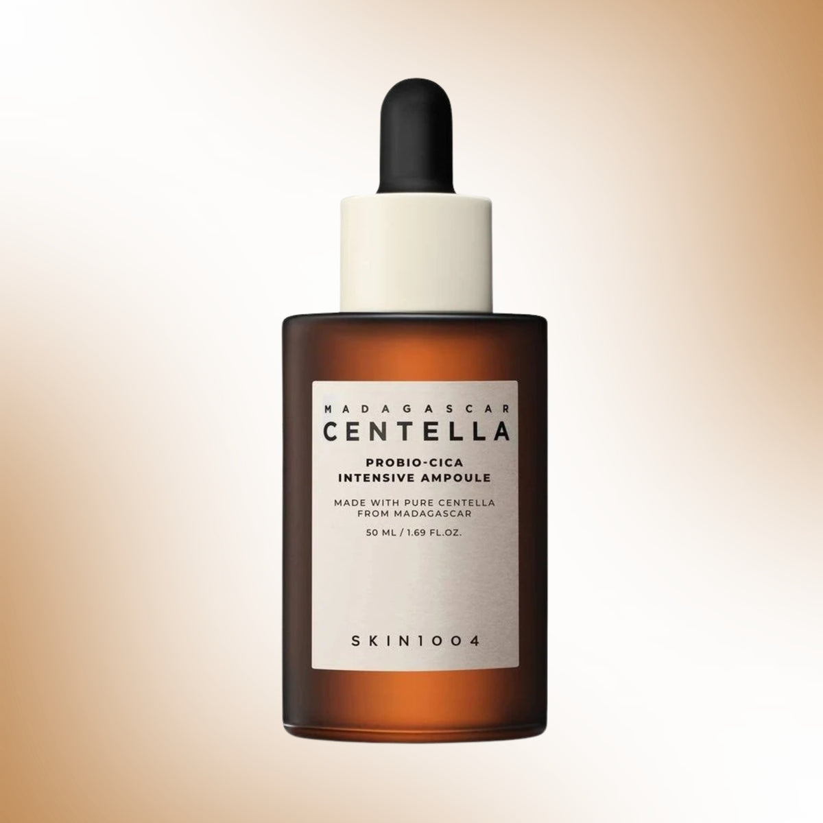 A 50ml amber glass dropper bottle of SKIN1004 Madagascar Centella Probio-Cica Intensive Ampoule, featuring a white label and a black dropper cap, set against a soft beige gradient background.