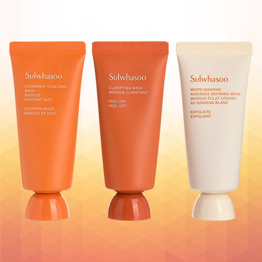 Sulwhasoo Mini Mask Kit  arranged side by side on a warm gradient background: an orange Overnight Vitalizing Mask tube, Clarifying Mask tube, and a White Ginseng Defining Mask tube.