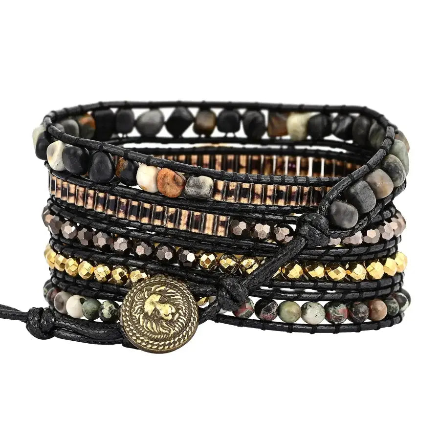 Multistrand beaded bracelet with leather cord and decorative button on a white background