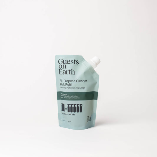 Guests on Earth Woodlands All-Purpose Cleaner bulk refill pouch on a white surface.
