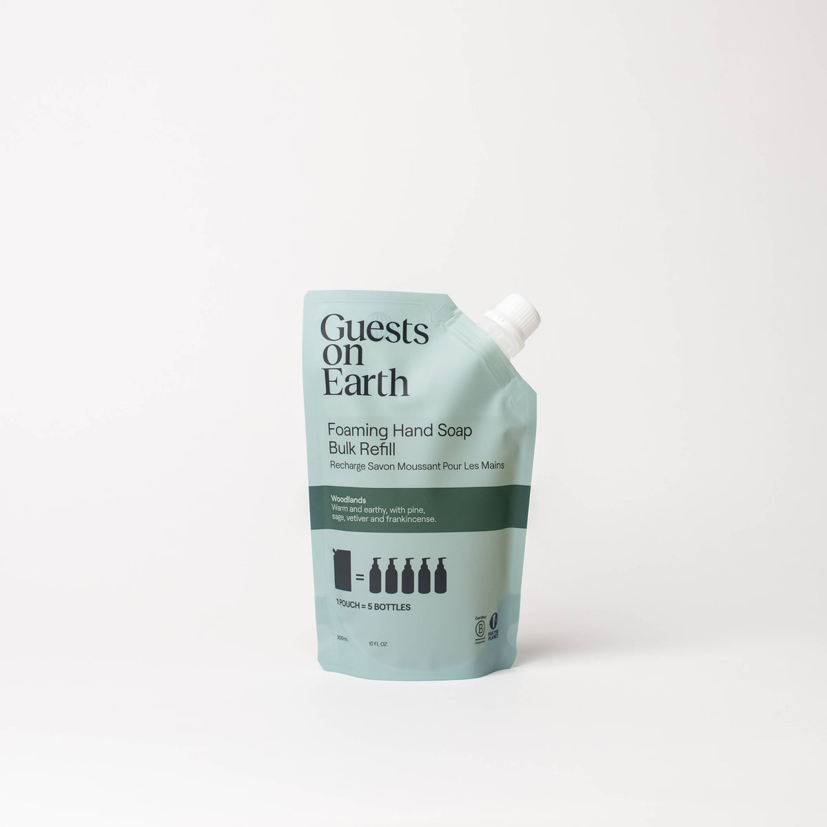 Guests on Earth Woodlands Foaming Hand Soap bulk refill pouch on a white surface.
