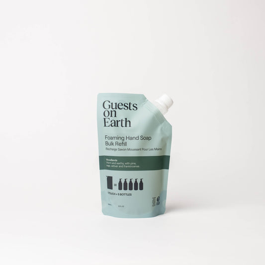 Guests on Earth Woodlands Foaming Hand Soap bulk refill pouch on a white surface.