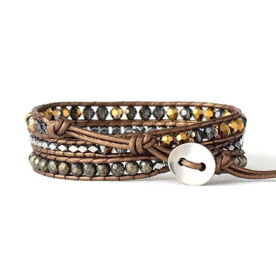 Brown leather bracelet with embedded stones on a white background