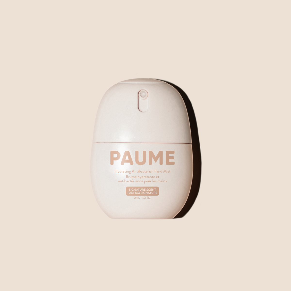 PAUME Hydrating Antibacterial Hand Mist in a rounded, capsule-shaped off-white bottle with a minimalist design, shown against a solid beige background with a soft shadow.