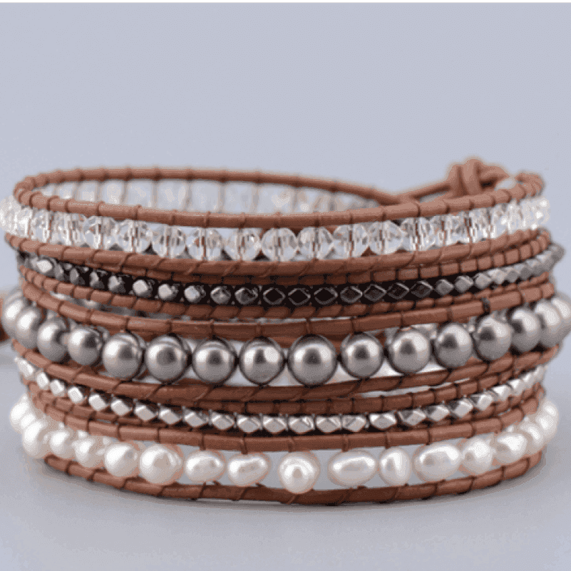 Multistrand bracelet with beads and pearls on a light gray background
