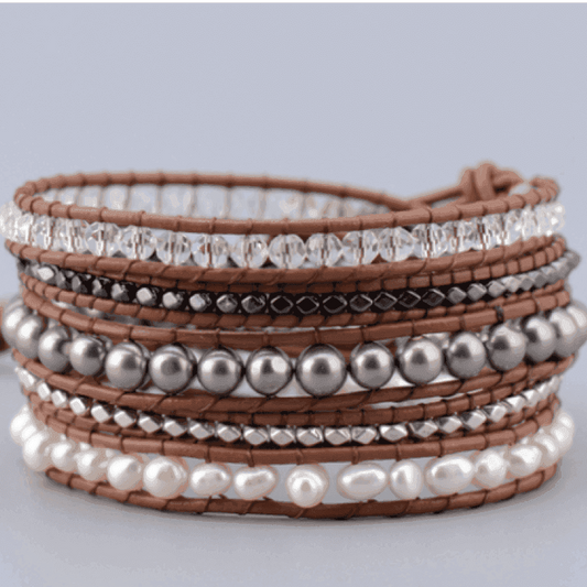 Multistrand bracelet with beads and pearls on a light gray background