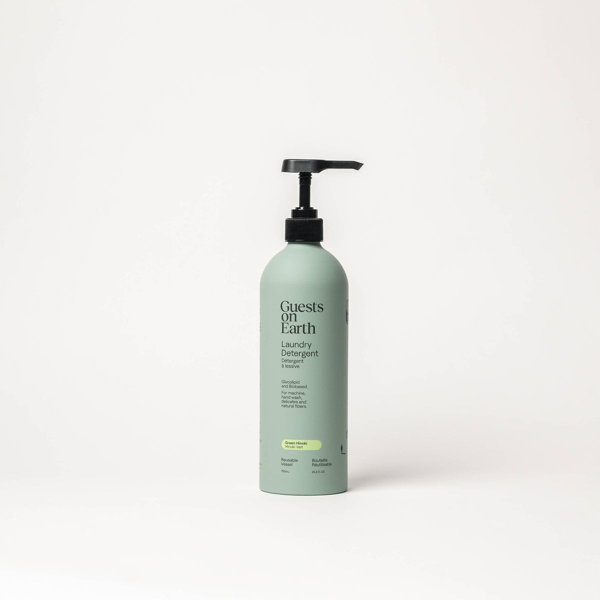 Guests on Earth Green Hinoki Laundry Detergent in a pale green bottle with a black pump.