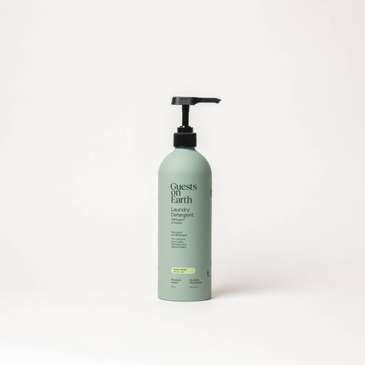 Guests on Earth Green Hinoki Laundry Detergent in a pale green bottle with a black pump.