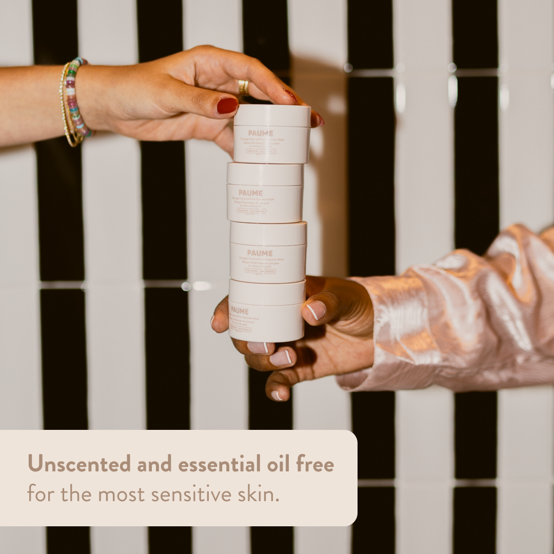 Stack of PAUME Overnight Hand & Foot Hydration Masks held by a person against a striped background