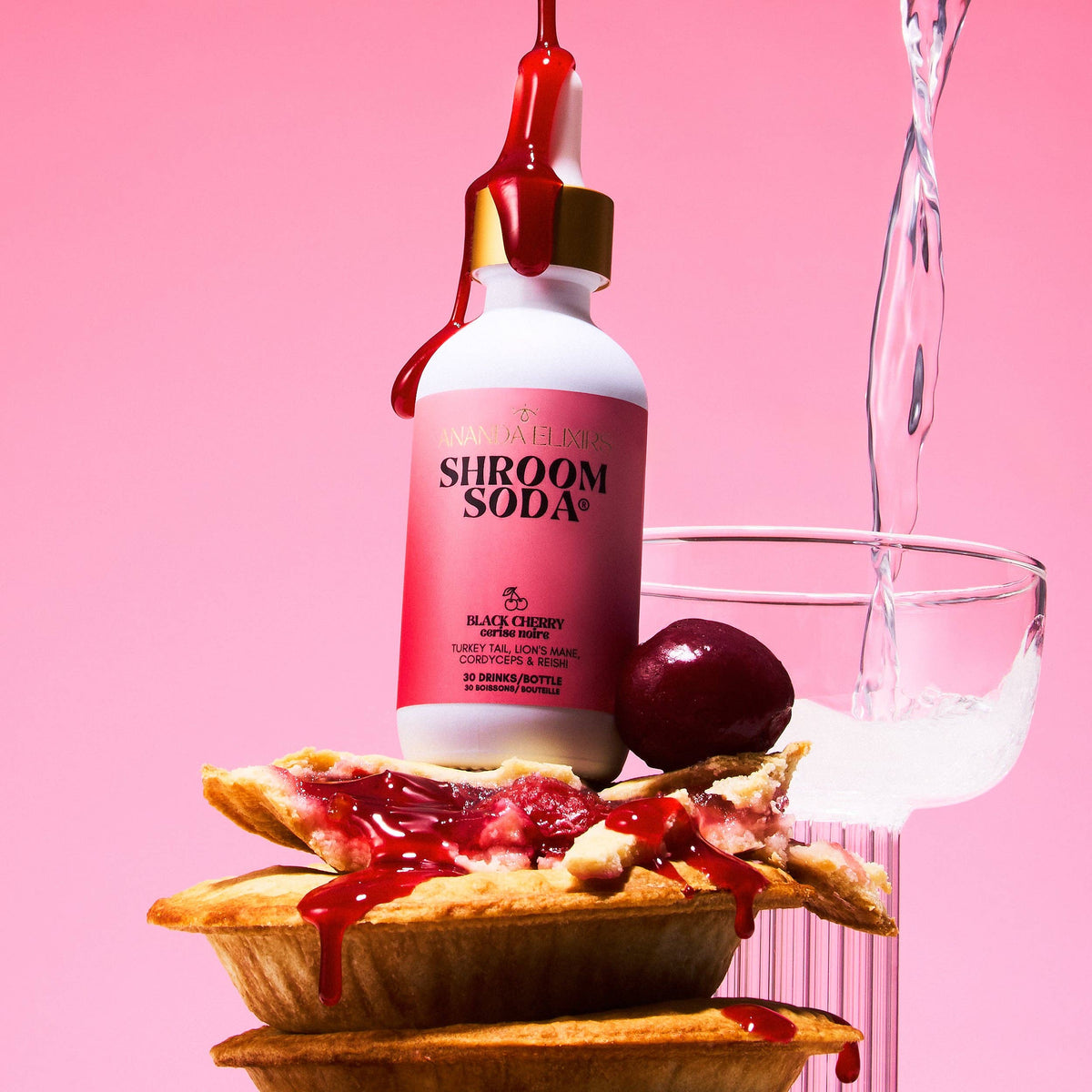 Shroom Soda Black Cherry over a pie on a pink background