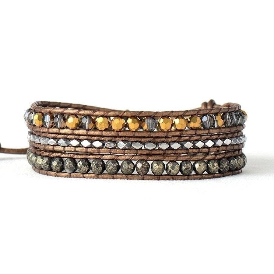 Multi-layered leather bracelet with embedded beads on a white background