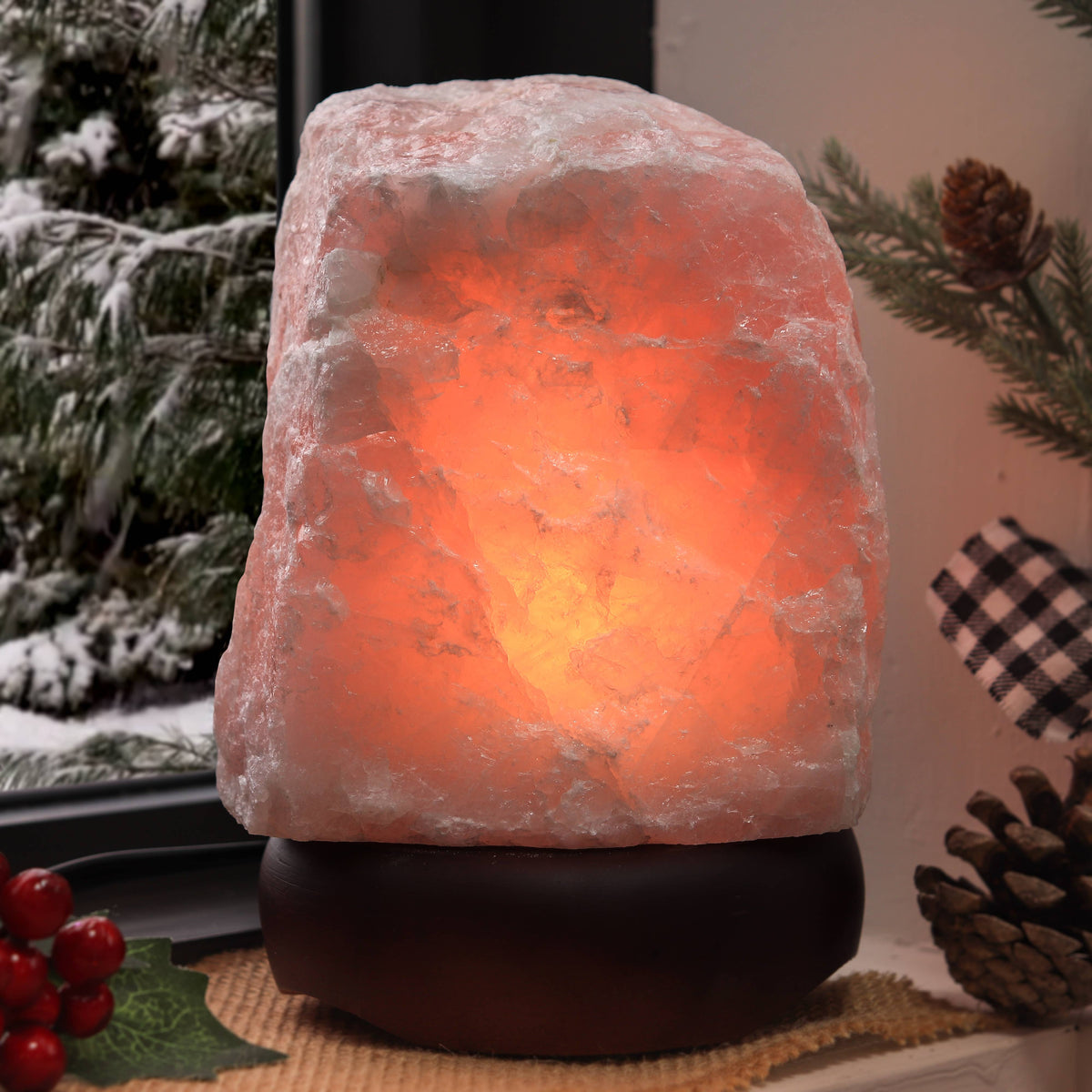 Rose Quartz lamp on a decorative surface with Christmas decorations.