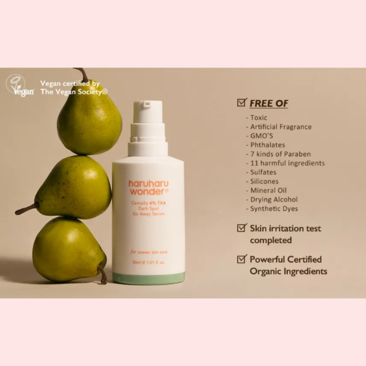 A bottle of haruharu wonder Centella 4% TXA Dark Spot Go Away Serum stands on a beige background next to three green pears, with text highlighting product benefits such as being free of artificial fragrance, phthalates, and harmful ingredients.