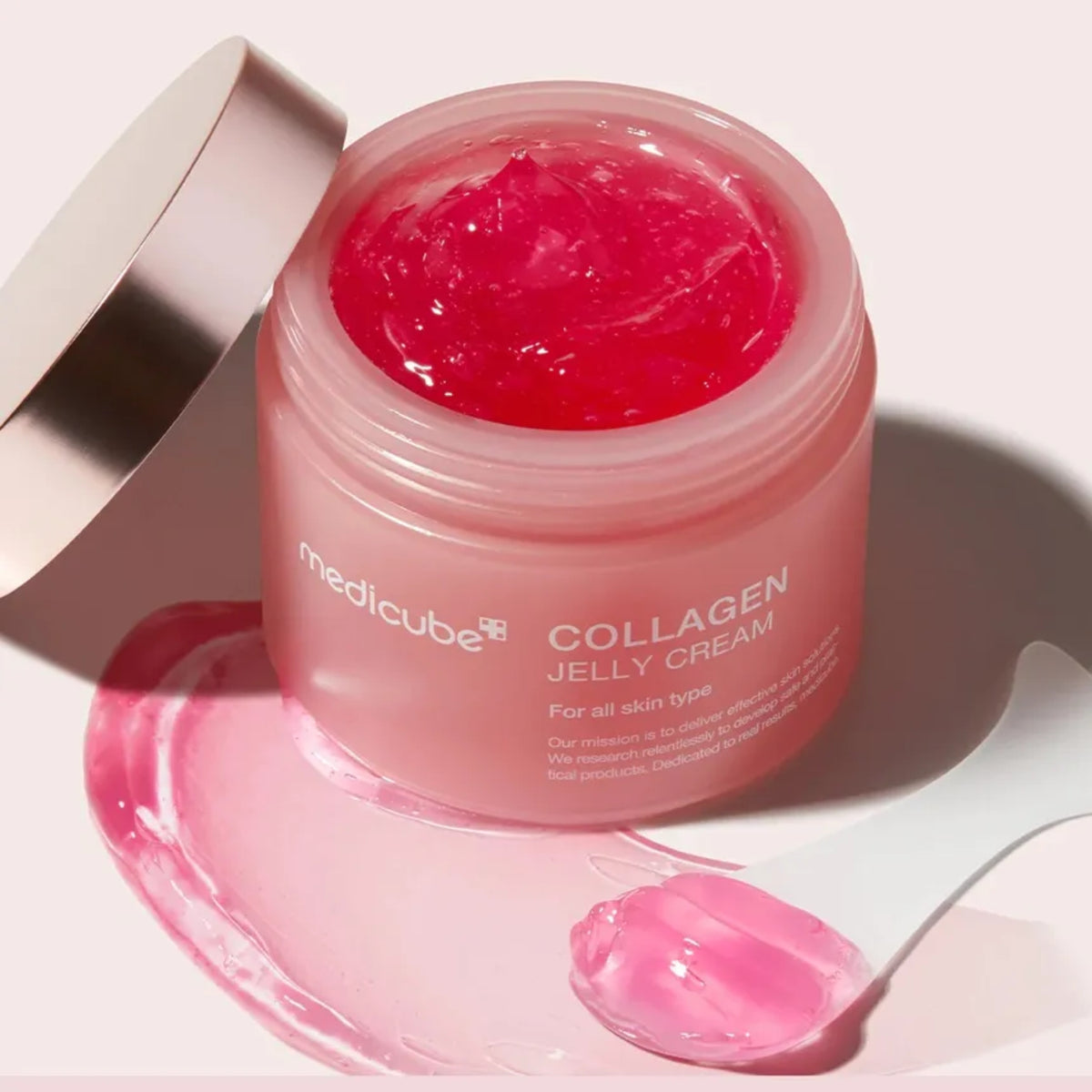 Pink jar of Medicube Collagen Jelly Cream on a light background