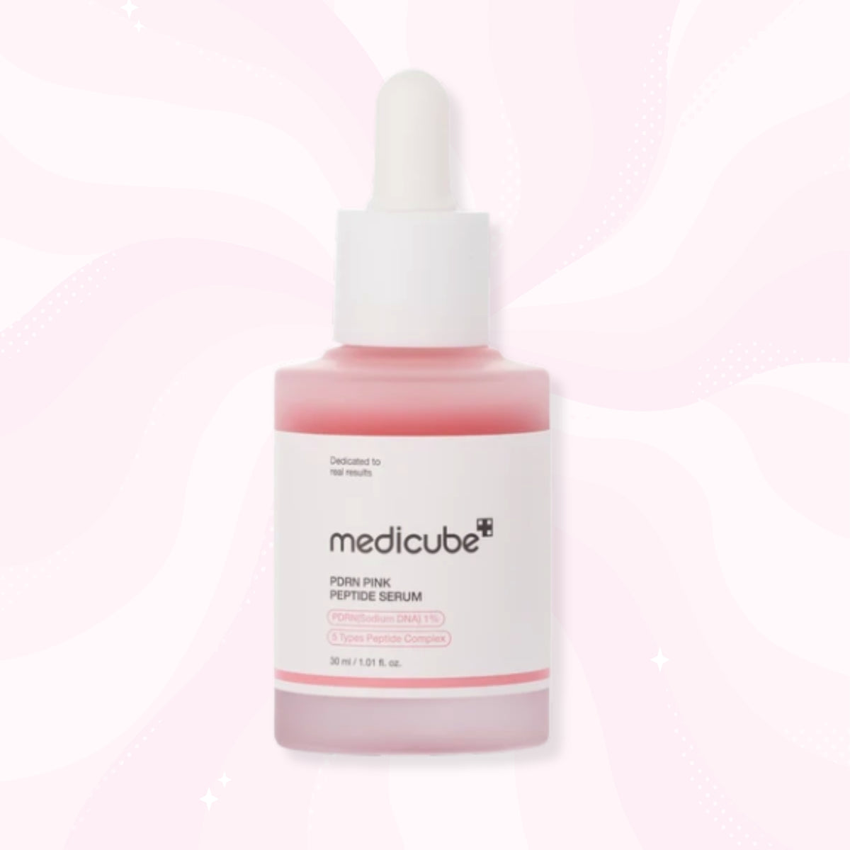 medicube PDRN PINK PEPTIDE SERUM in a frosted glass dropper bottle with pink liquid inside and a white label, set against a light pink wavy background.